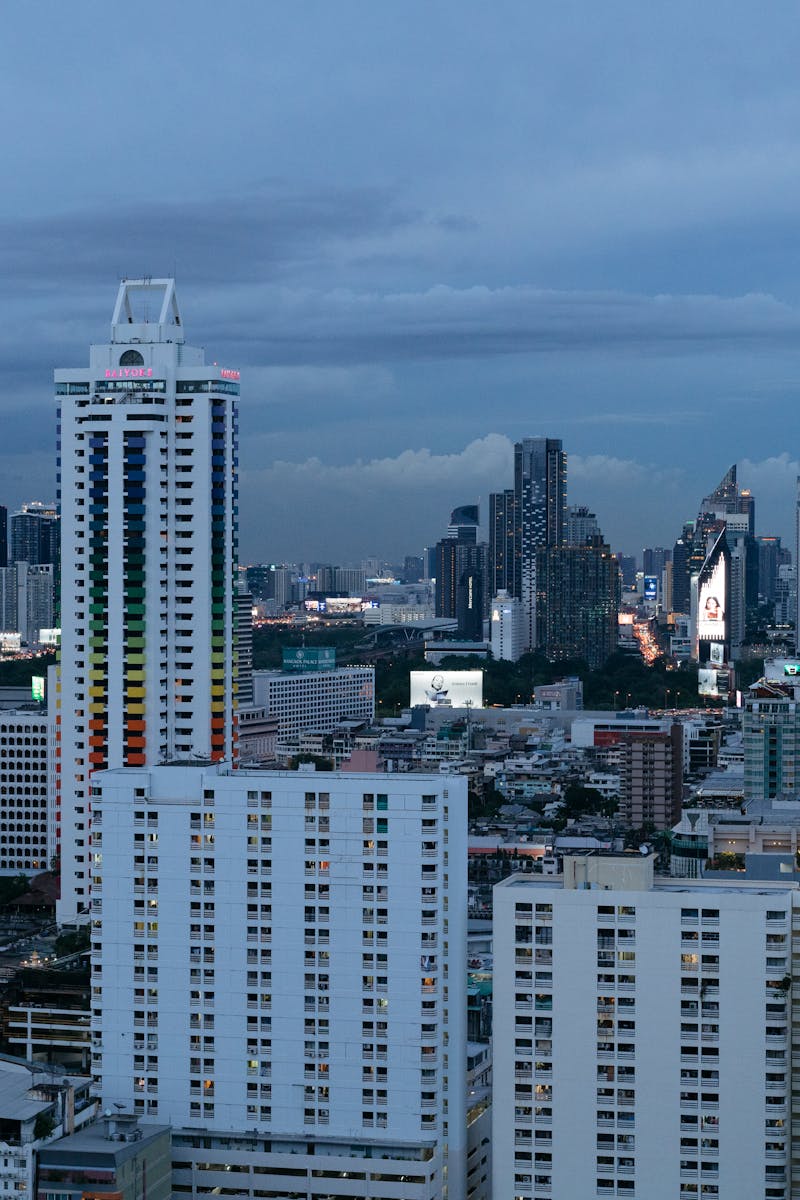 A dramatic view of Bangkok's skyline during dusk, showcasing vibrant skyscrapers.